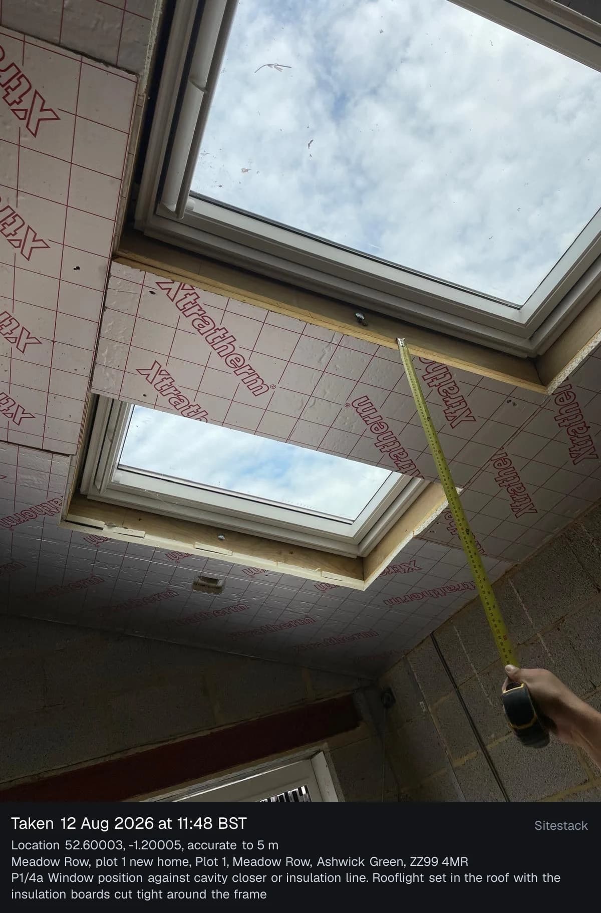 A rooflight photo on an office screen with a stamp printed below it giving the date and time, the GPS location and its accuracy, the site address and the Part L reference P1/4a.