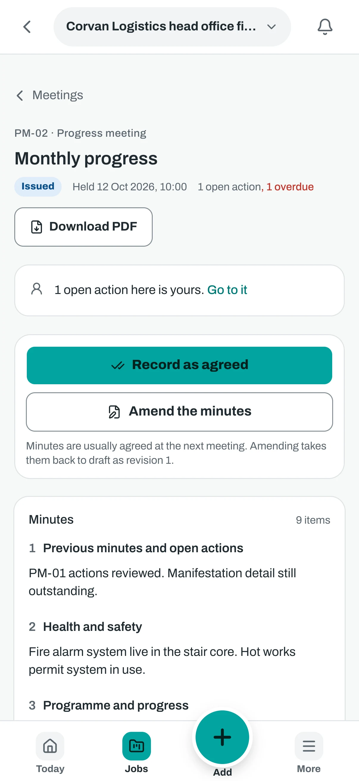 The same meeting on a phone, with the open action and the button to record the minutes as agreed.